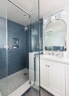 Subway tile for shower walls in staggered pattern and mosaic tile for shower pan