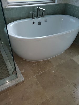 Kholers freestanding soaker tub with air jets and heating surface.