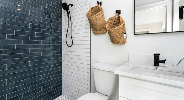 The best way to elevate your bathroom is adding a tiled accent shower wall!