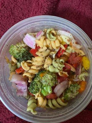 The pasta salad has the perfect amount of spiral noodles, broccoli, red onion, and colorful peppers.