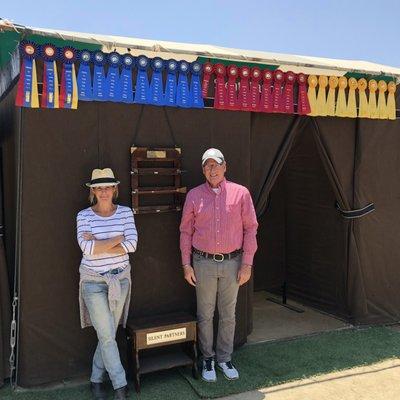 Trainers Janene Davis and Chris Land at a horse show with the weekend's winnings.