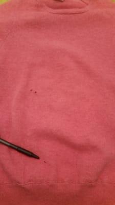 1 of 3 holes found on front of sweater after Lyon's cleaning