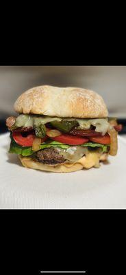 The OG Burger, bacon, grilled onions, grilled jalapeños, chipotle mayo, pepper Jack cheese, lettuce and tomato.