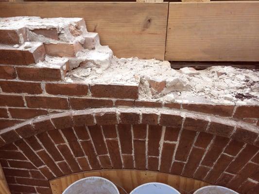 Removed and replaced damaged floor joists before brick reconstruction