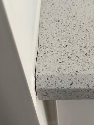 cracked grout instead of caulk at cabinet edge