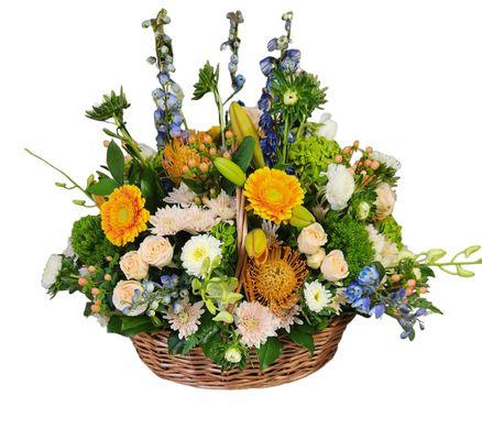 Large wicker basket in shades of peach, orange and a pop of blue