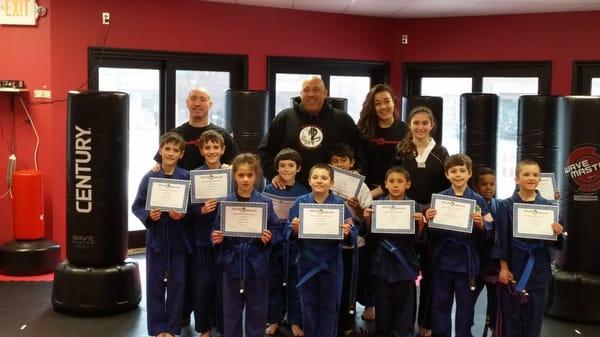 Students show off their new belts after a promotion