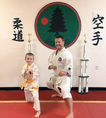 My son posing with Sensei after earning his gold belt.