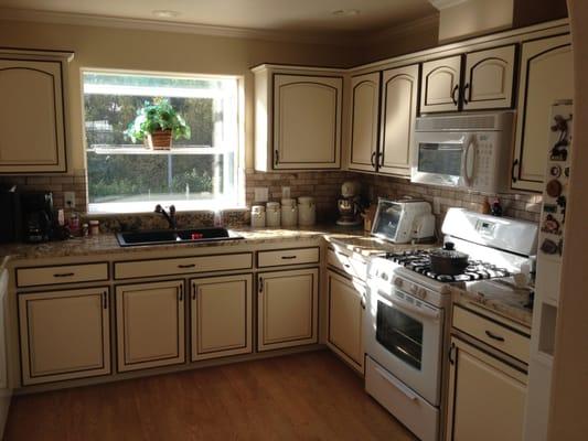 Re painted kitchen cabinets with two tone detail.