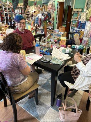 Ben, the owner, patiently helping some knitters.