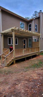 Beautiful covered deck with tasteful pergola design.