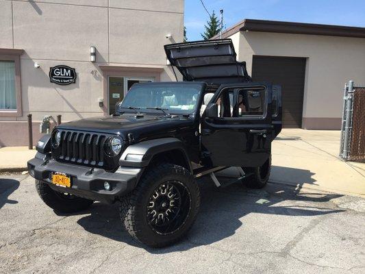 Shown here - Jeep Wrangler with custom diamond stitched leather interior parked in front of our location!