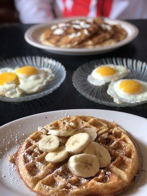 Banana nut waffle and cinnamon roll pancakes with fried eggs!