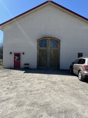 Entrance to the venue is the red door next to these beautiful wooden doors.