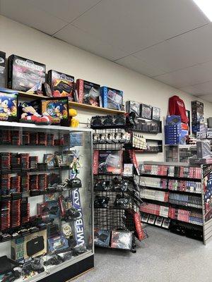 Display of genesis consoles and games.