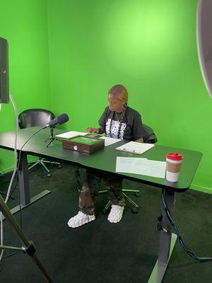 Comedian Roni Raw prepares for her podcast using our green screen wall.