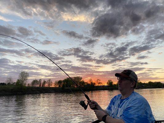 Fighting a fish at dusk