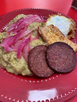 A hefty breakfast of mangu, salami, fried egg, fried cheese and pickled onions.