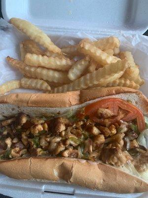 Chicken Philly with grilled onions peppers, lettuce, tomato and white cheese with fries.