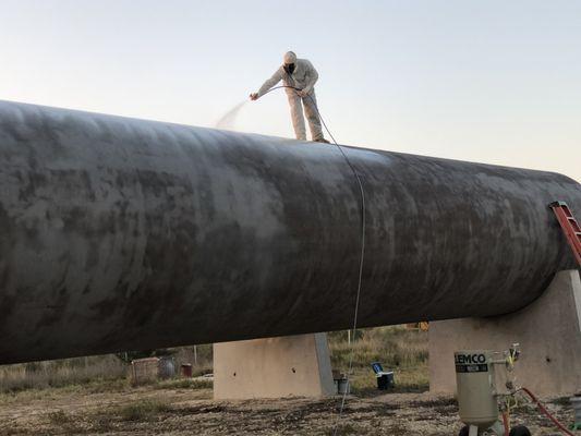 Coating tanks with industrial primer