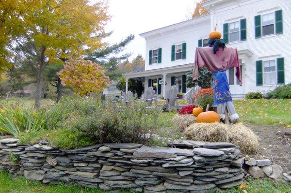 Autumn scarecrow and pumpkins.