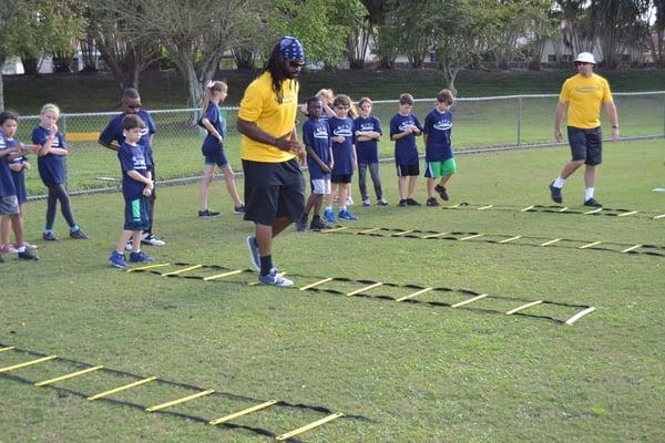 Coach Steve Josue showing the kids the ladder drill at Central Park Elementary's after care.