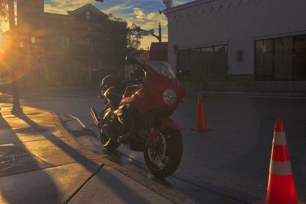 Just at the entrance of the garage, the sun illuminate the bike.