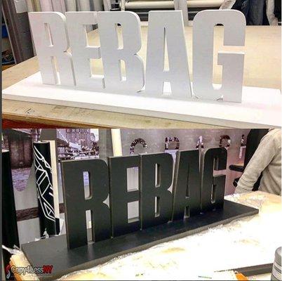 Rebag logo 1" thick pvc white and black 31.81"w x 12"- with a base since it needs to sit on a shelf