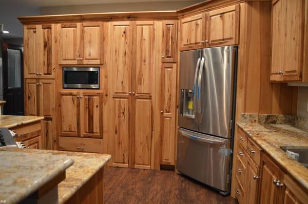 Open kitchen design with stainless steel appliances worked seamlessly into a cohesive cabinet plan.