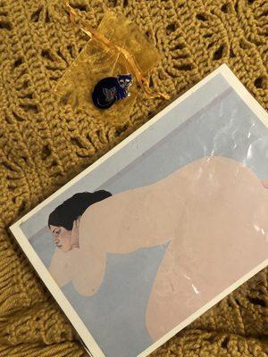 Print of a woman and cat pin.