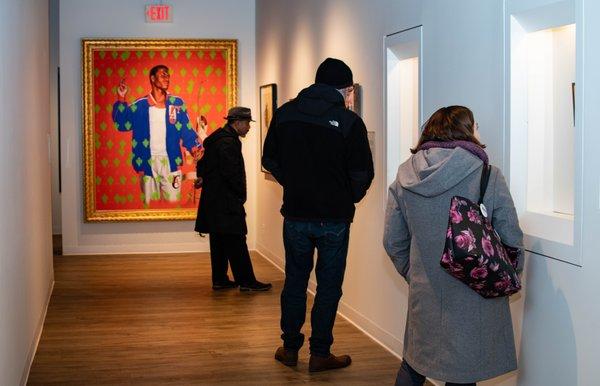 Visitors admiring artworks on view during the opening of "Examining Identity Construction," February 2020.