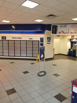 Self service machines next to Post Office boxes