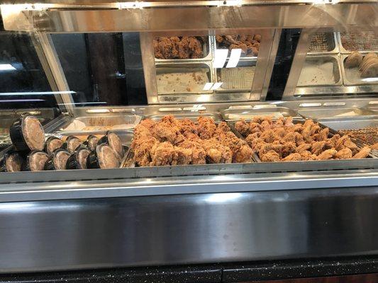 Nice selection of fried chicken, chicken wings, chicken tenders, Cajun rice and meat pies.