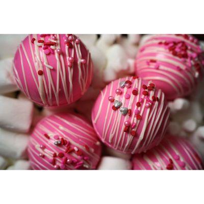 White chocolate hot cocoa bomb dyed pink for Valentine's Day