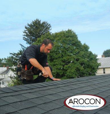 Our AROCON technician performing a roof and gutter tune-up on an asphalt shingle roof!