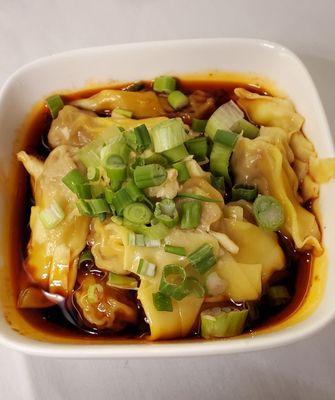 Wontons in Chili Oil. Tender tiny pork wontons in a spicy chili oil, with scallions, garlic, and a little black vinegar. Very good.