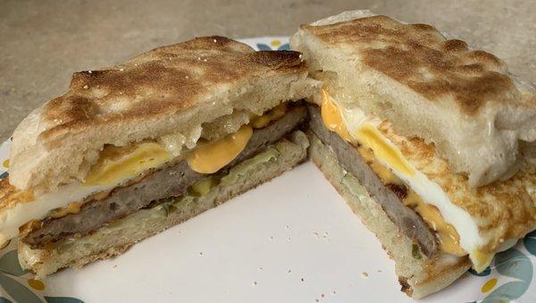 Sausage egg and cheese on an English muffin and pickles. Delicious