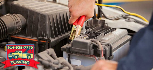 Harrison Tow Truck Company towing mechanic giving a jump start to disabled car vehicle with a dead battery Rye Mamaroneck Por...