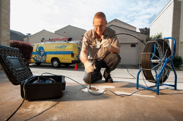 Our Plumber running a camera through a clean out for a sewer line.