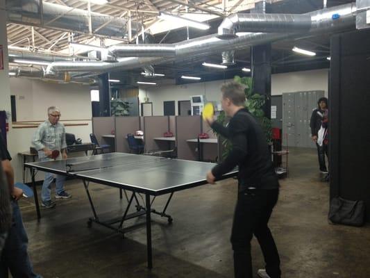 Student playing ping pong with Ralph Humphrey