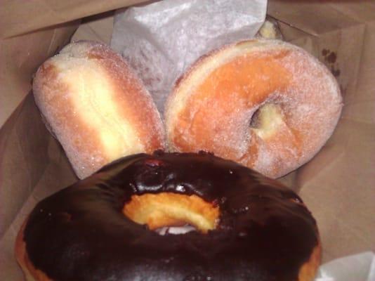 Chocolate-iced and sugar doughnuts in the bag.