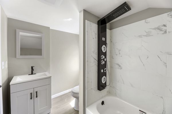 Complete Bathroom remodel floor to ceiling with tiled shower and new shower technology called a "shower tower"