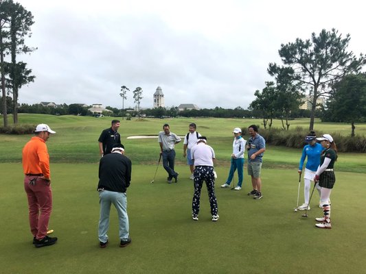 A group golf clinic, working on the putting stroke.