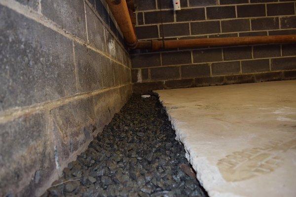 Basement waterproofing system NJ. 3/4 inch clean stone is used to cover the trench.