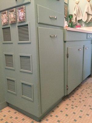 Custom bathroom cabinet with built in hamper matches existing bathroom cabinet.