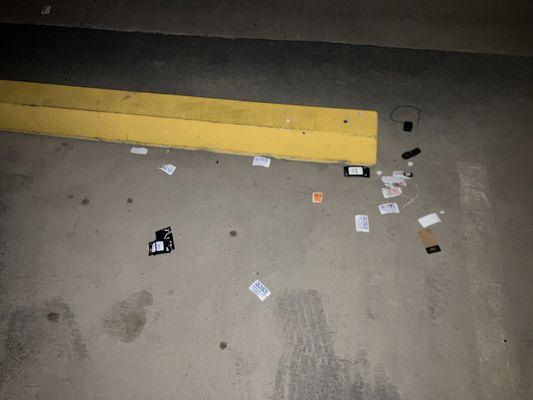 Photo of broken anti-theft devices and Ross tags found in the parking lot of the complex.