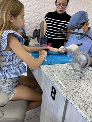 My granddaughter having her nails done with Don and Jenny