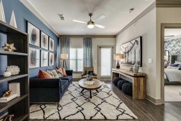 Living area with wood-style floors, French door to patio, and large window.