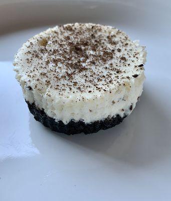 Petite Cookies and Cream Cheesecake with grated chocolate on top.