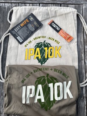 Race packet swag: tech t-shirt, handy backpack style drawstring bag, hydration packet and convenient post workout body towel/wipe sample.